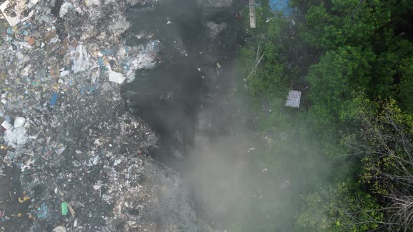 Open burning garbage at dump site.