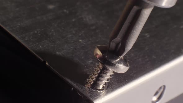 Closeup Shot of Inserting a Screw Into a Hard Drive