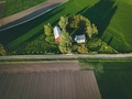Aerial view of farmland with red barn and houses and harvest field in Finland - PhotoDune Item for Sale