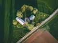 Aerial view of farmland with red barn and houses and harvest field in Finland - PhotoDune Item for Sale