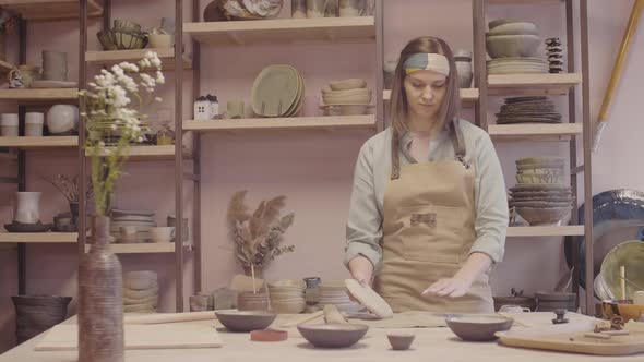 Woman Working Clay Using Rolling Pin