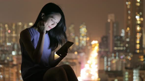 Woman use of smart phone at night