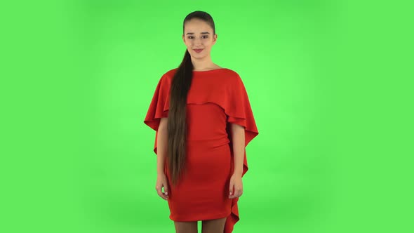 Pretty Young Woman Is Looking Straight. Green Screen