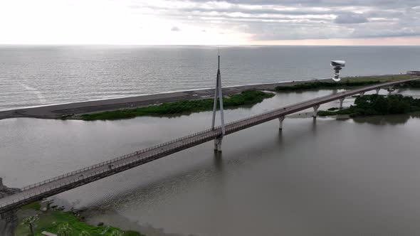 Anaklia, Georgia - July 16 2022: Aerial view of Anaklia-Ganmuhkuri Pedestrian Bridge at sunset