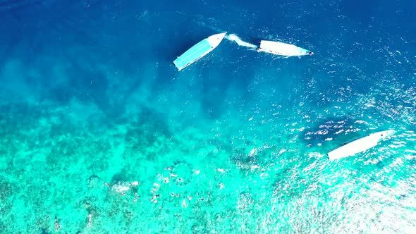 Aerial above scenery of marine shore beach voyage by blue ocean and bright sandy background of a day