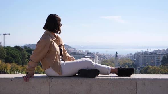 Gorgeous Thai tourist enjoys view over the city Lisbon in Portugal, slow motion