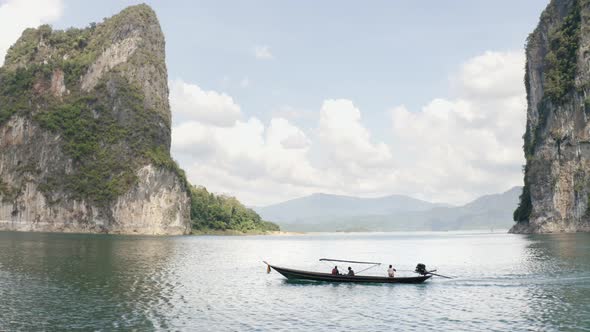 Boat Sailing Between the Mountains Over the Lake