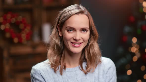 Closeup Portrait of Beautiful Laughing Woman Posing at Christmas Tree