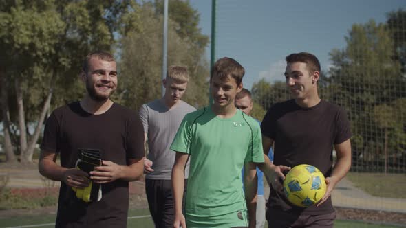 Footballers Preparing To Play Soccer Game Outdoors