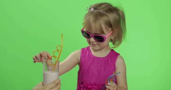 Happy Four Years Old Child in Pink Dress Drinks Milkshake Cocktail. Chroma Key