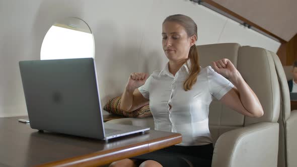 Business Lady Use Notebook on Business Private Jet Board