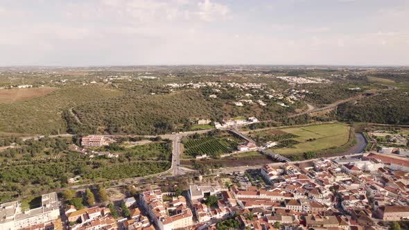Aerial wide fly-over Algarve Castle of silves from Arade River outskirts