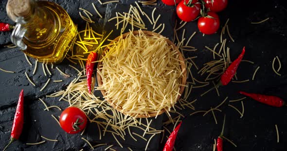 Dry Pasta Vermicelli with Peppers, Tomatoes Slowly Rotates. 