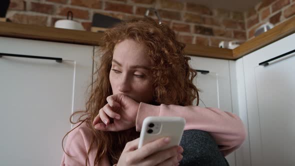 Close up and handheld video of anxious young caucasian woman using mobile phone.