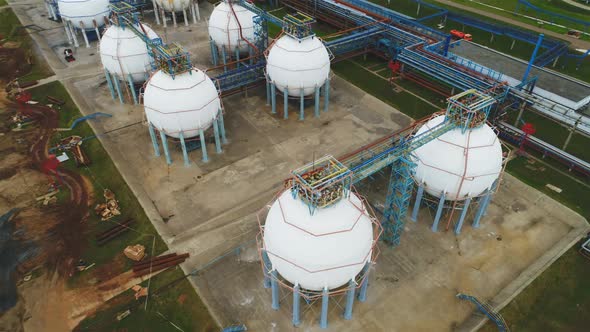 Camera Moves Up Above Spherical Reservoirs and Refinery Complex