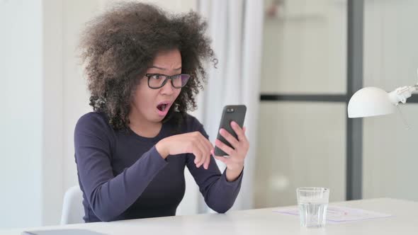 African Woman Having Loss While Using Smartphone