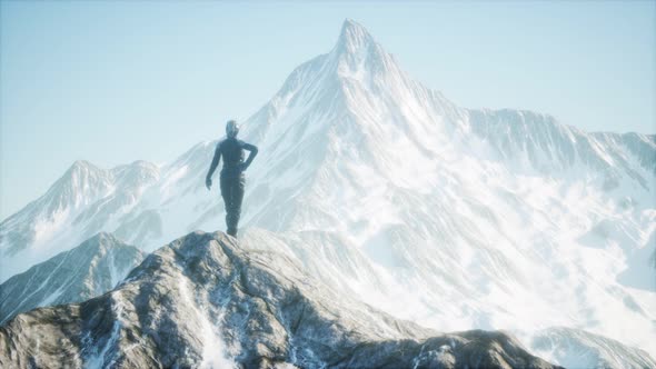 Woman Standing In Snow Wearing Warm Clothes In Mountains alt