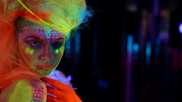 Artistic Makeup and Body Art with Fluorescent Paints Female Portrait in Darkness