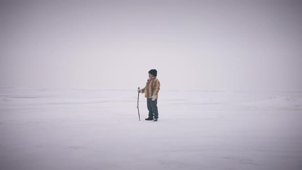 Extreme Wide Shot Happy Confident Senior Adventurer Standing on White Picturesque Polar Landscape