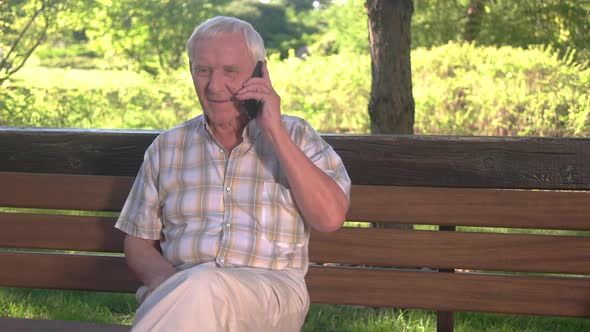 Smiling Elderly Man with Phone.