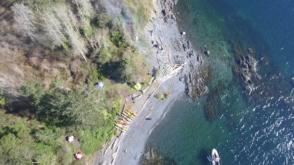 Aerial view of group cleaning up remote island on the Pacific.