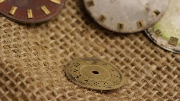 Rotating stock footage shot of antique and weathered watch faces - WATCH FACES 019