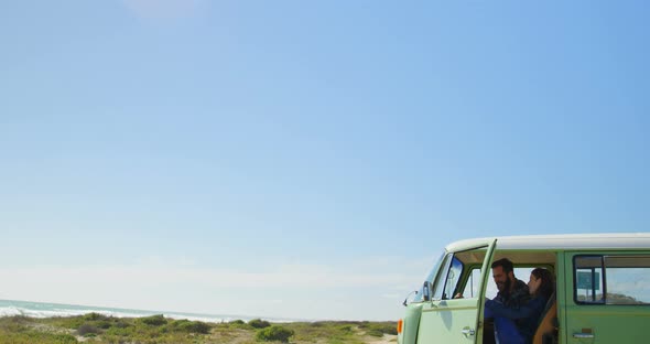 Couple sitting in van on a sunny day 4k