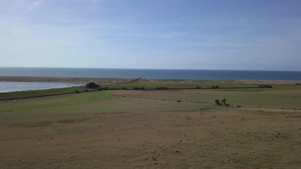 Aerial tracking and rotating from right to left looking across the fleet lagoon and Chesil Beach, Do