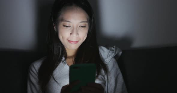 Woman looking at mobile phone at home 