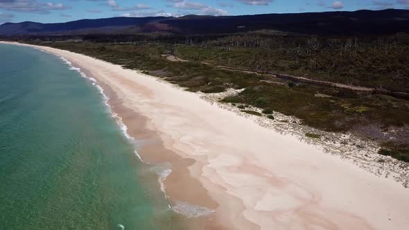 Drone PAN Over White Sand Beach and Blue Ocean Coast In Tasmania, Australia