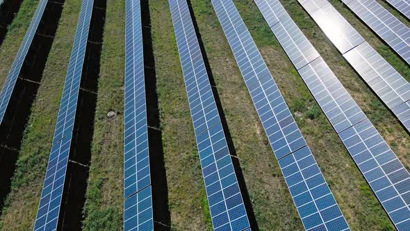 Aerial View and Drone Flight Over Lines of Solar Panels