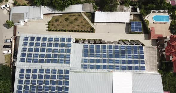 Drone Descending Over Commercial Rooftop Solar Installation