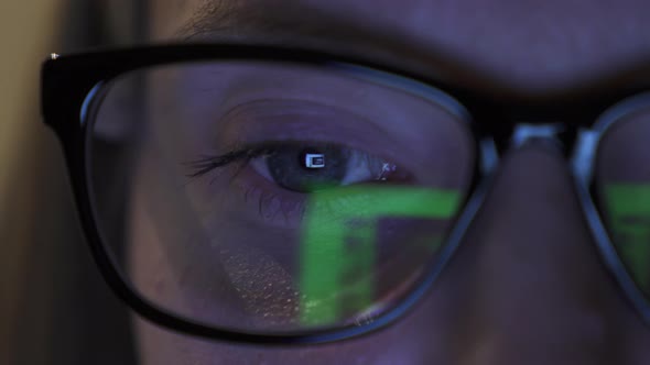 Detailed View on Girl's Eye in Glasses, Reflection of Screen of Laptop in Eye