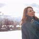 Young Redhaired Woman in a Blue Coat and Walks Against the Backdrop of the Old City - VideoHive Item for Sale