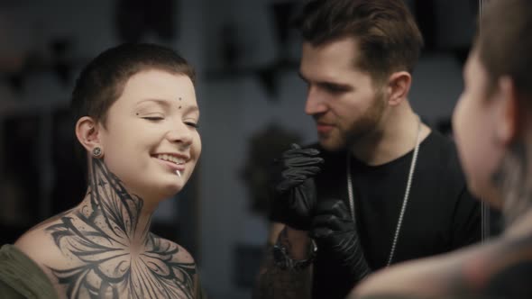 Caucasian man and woman checking what the tattoo looks like after the tattooing. Shot with RED heliu