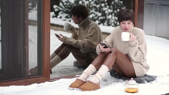 Peaceful Young Woman Drink Tea on Home Terrace in Winter