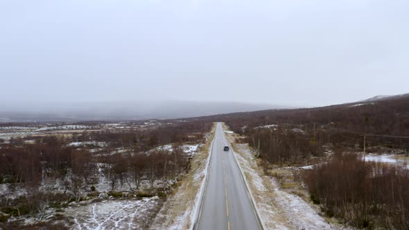 Car On The Road In Winter Forest With Snow Covered Landscape - Snowy outdoor scene - Traveling conce