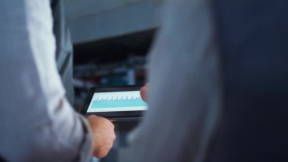 Farmer Hands Using Tablet Computer at Farm Closeup