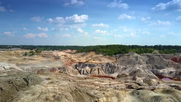 Huge Clay Quarry Against Forest Under Blue Sky