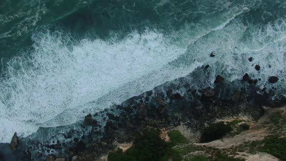 Top View of The Giant Waves, Foaming and Splashing in The Ocean Near the Cliffs, Bali, Indonesia