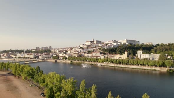 Aerial view, Coimbra ancient city panorama Landscape through Mondego river, Dolly shot