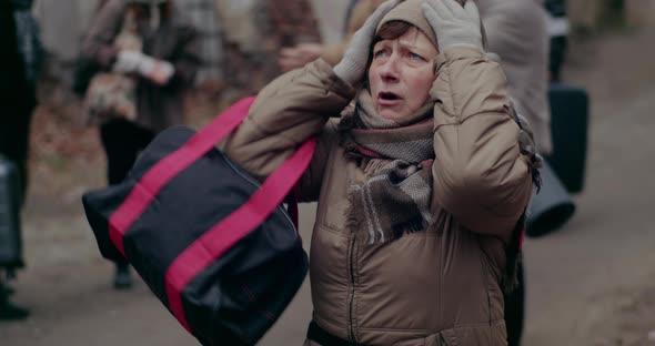 Female Immigrant Rubbing And Praying In Cold During War Crisis