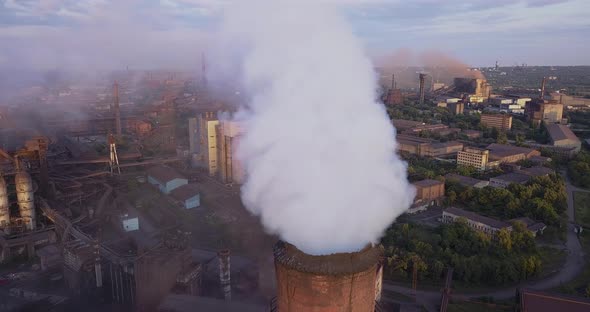 Aerial View of Industrial Zone with a Large Pipe Thick White Smoke