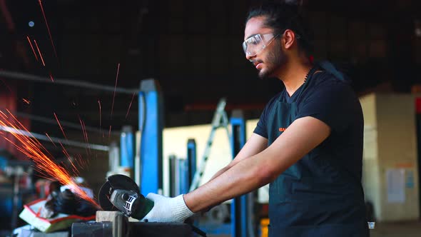 Latin Hispanic Auto Mechanic in Uniform is Examining a Car While Working in Auto Service