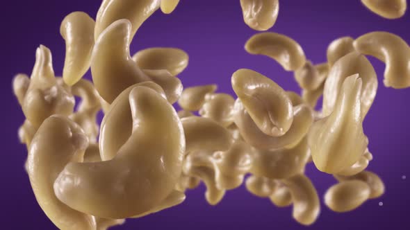 Flying of Cashews in Purple Background