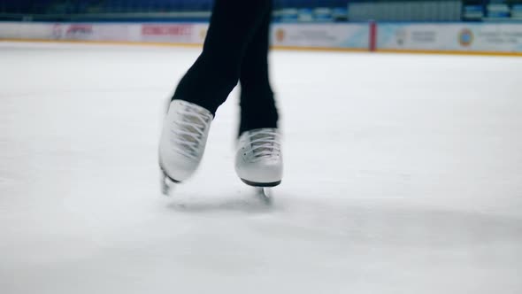 Close Up of Athlete's Legs in Ice Skating Shoes While Spinning