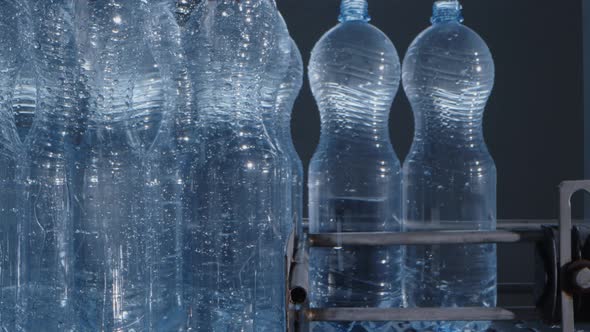 Water Bottles Moving on Automatic Conveyor Line in Water Production Factory