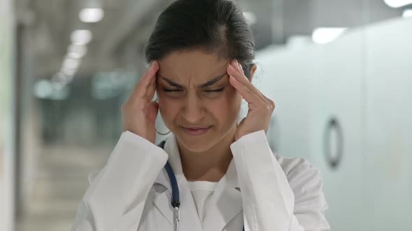 Portrait of Exhausted Indian Female Doctor Having Headache