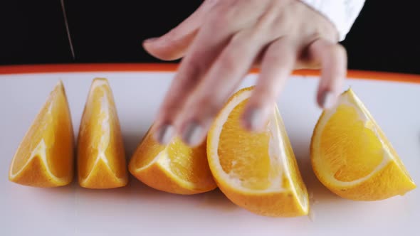 The Big Orange Is Being Cut and Sliced on a Cutting Board