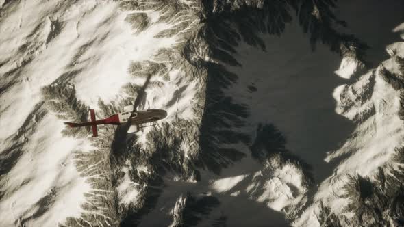 Helicopter Above Mountains in Snow